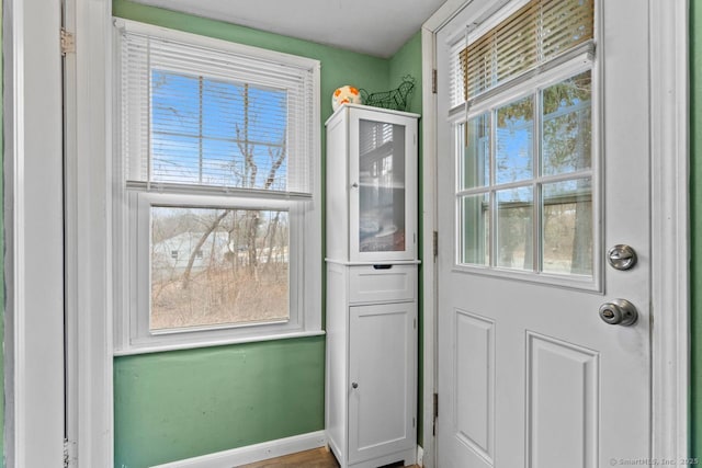 doorway to outside with baseboards