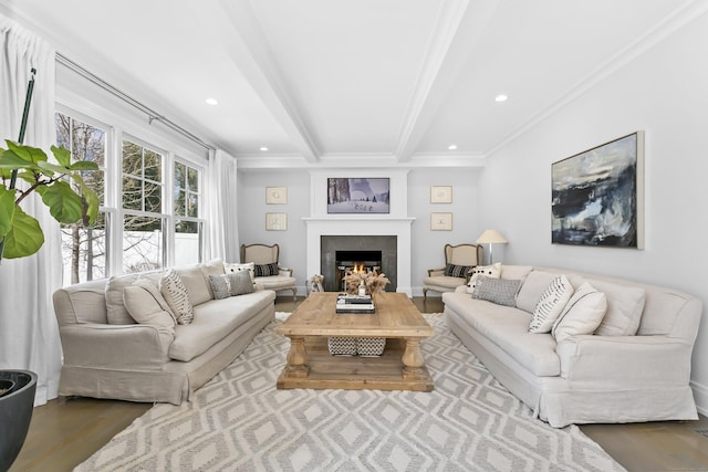 living area featuring wood finished floors, a lit fireplace, crown molding, beam ceiling, and recessed lighting