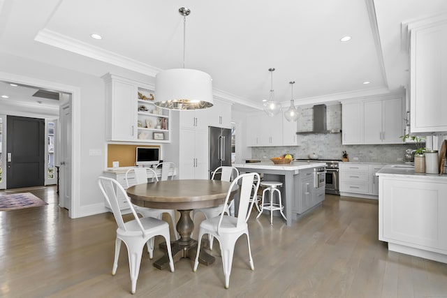 dining area with dark wood-style floors, ornamental molding, and recessed lighting