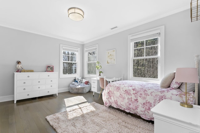 bedroom with visible vents, ornamental molding, hardwood / wood-style flooring, and baseboards