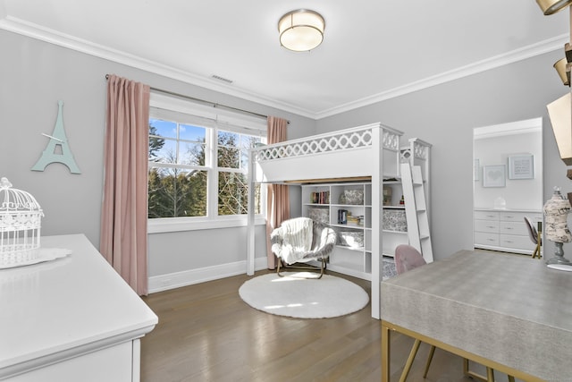 bedroom with ornamental molding, wood finished floors, visible vents, and baseboards