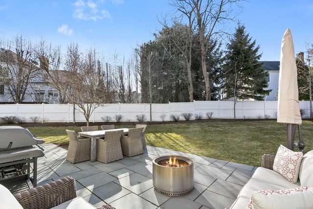 view of patio with an outdoor fire pit, a grill, outdoor dining area, and a fenced backyard