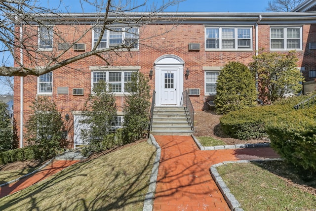 view of front of home featuring brick siding and entry steps