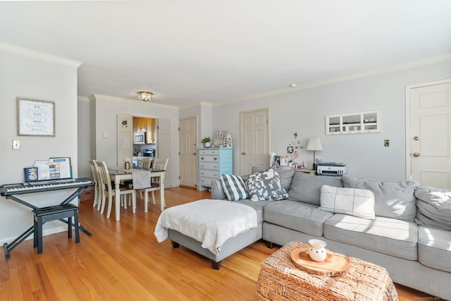 living area with light wood-style floors and ornamental molding