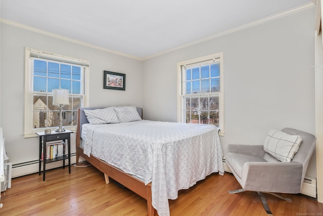 bedroom featuring light wood-style flooring, crown molding, and a baseboard radiator