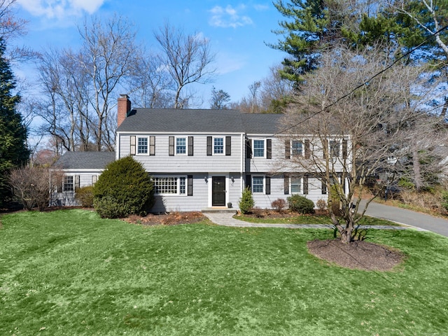 86 Stoneleigh Sq, Fairfield, CT 06825 - view of front facade featuring a chimney and a front lawn