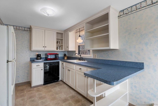 kitchen with open shelves, a sink, wallpapered walls, freestanding refrigerator, and dishwasher