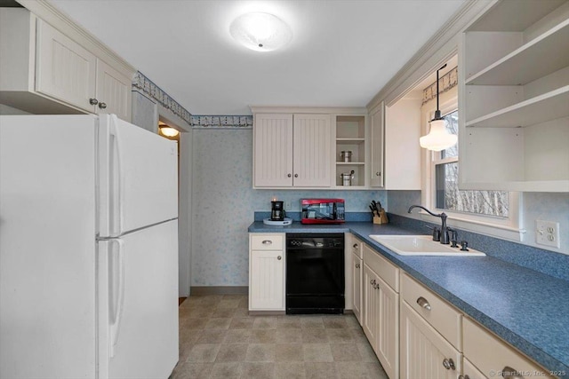 kitchen featuring open shelves, a sink, wallpapered walls, freestanding refrigerator, and dishwasher