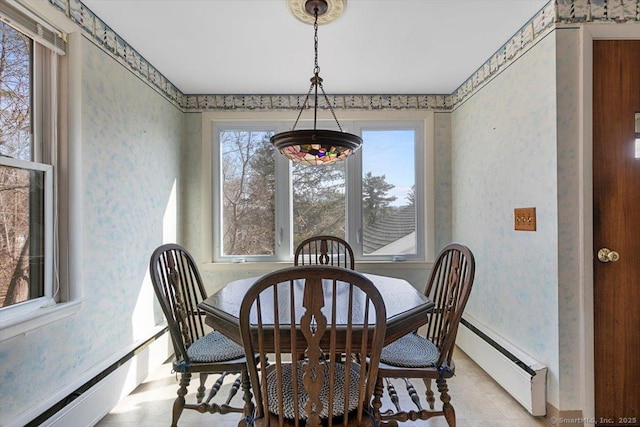 dining area with wallpapered walls and a baseboard radiator