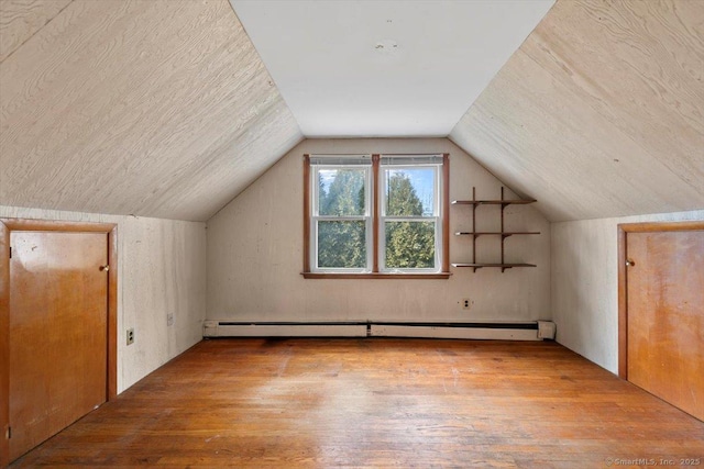 bonus room featuring hardwood / wood-style floors, a baseboard heating unit, and lofted ceiling
