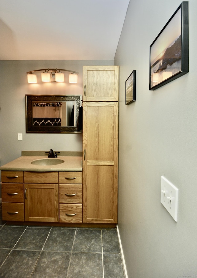 bathroom with baseboards and vanity