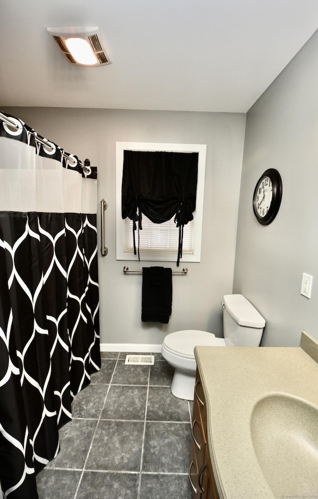 bathroom featuring baseboards, visible vents, vanity, and toilet