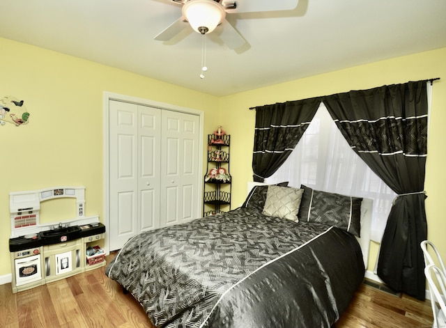 bedroom featuring a closet, wood finished floors, and a ceiling fan