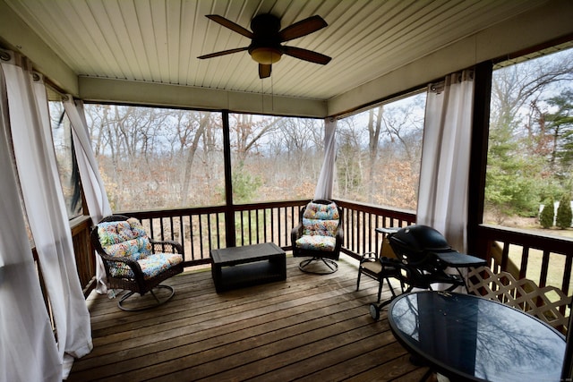 sunroom / solarium with ceiling fan and wooden ceiling