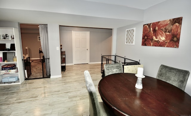 dining area featuring baseboards and wood finished floors