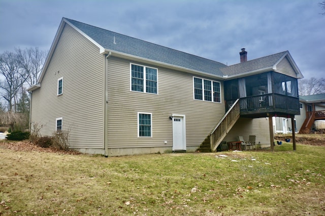 rear view of property with a chimney, stairway, and a lawn