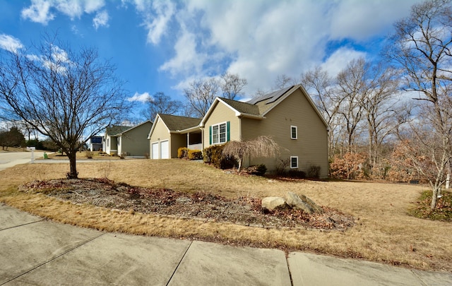 view of front of property with a garage and solar panels