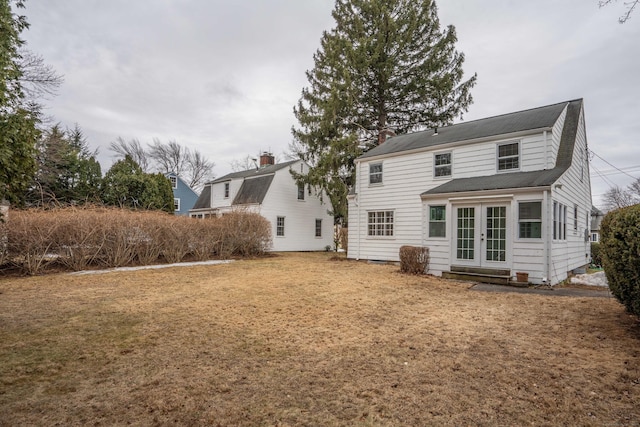 rear view of property featuring a yard and french doors