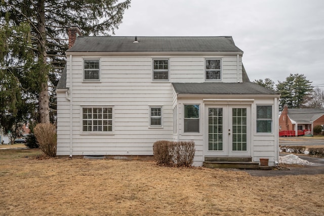 back of property featuring french doors and a chimney