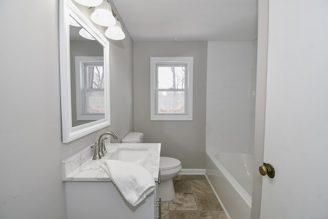 full bath with toilet, vanity, and baseboards