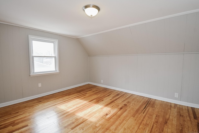 bonus room with lofted ceiling, baseboards, and hardwood / wood-style floors