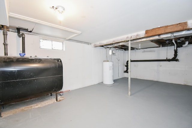 basement with electric water heater and heating fuel