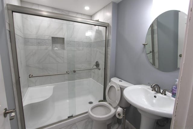 full bath with toilet, a stall shower, marble finish floor, and a sink