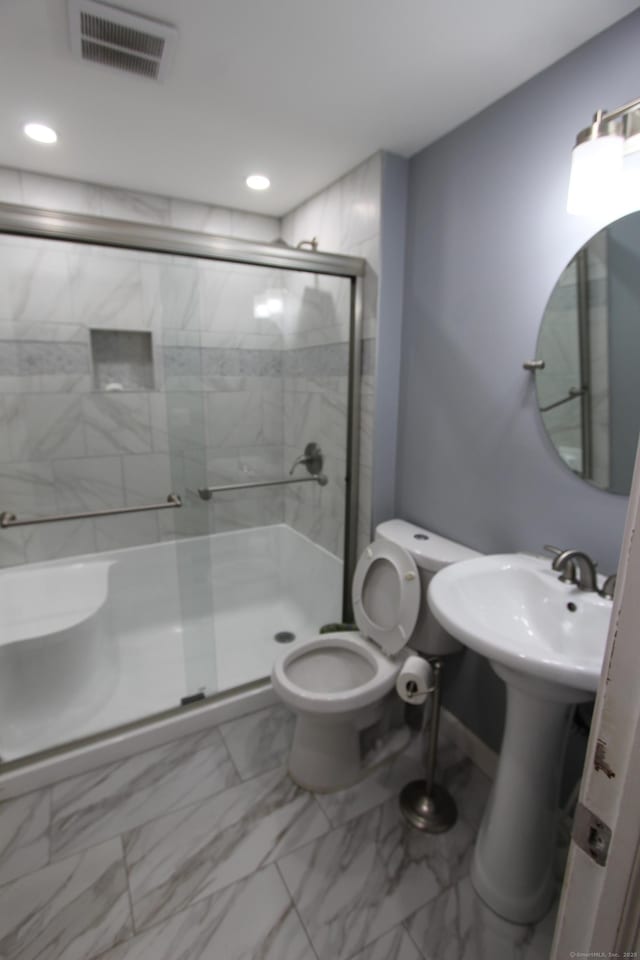 full bathroom with toilet, a sink, visible vents, marble finish floor, and a shower stall