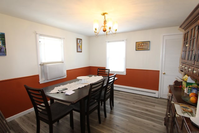 dining space featuring dark wood-style floors, wainscoting, a baseboard radiator, and a notable chandelier