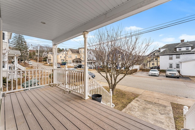 wooden terrace featuring a porch and a residential view