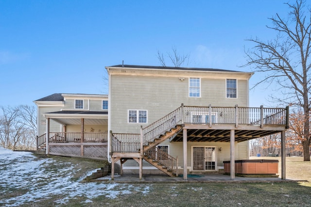 back of property featuring a hot tub, stairs, a deck, and a patio