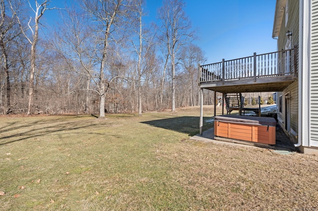 view of yard with stairway, a hot tub, and a wooden deck