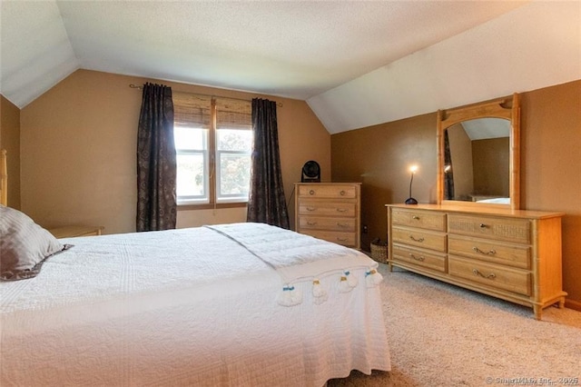 bedroom featuring lofted ceiling and light colored carpet