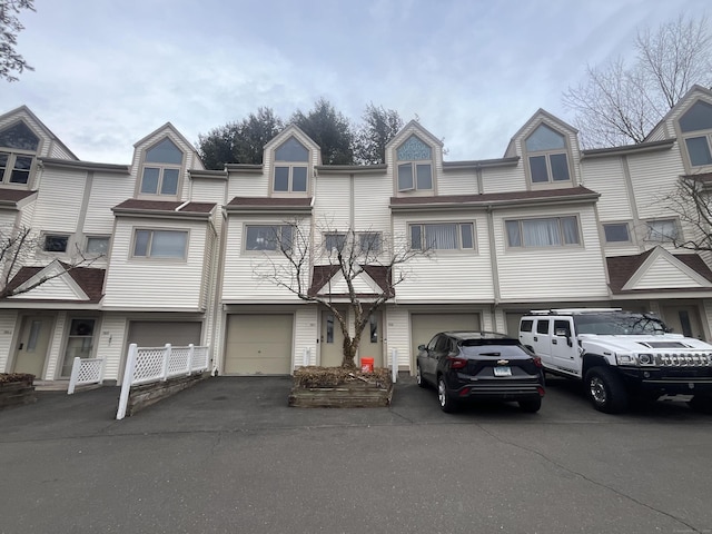 view of property featuring a garage and driveway