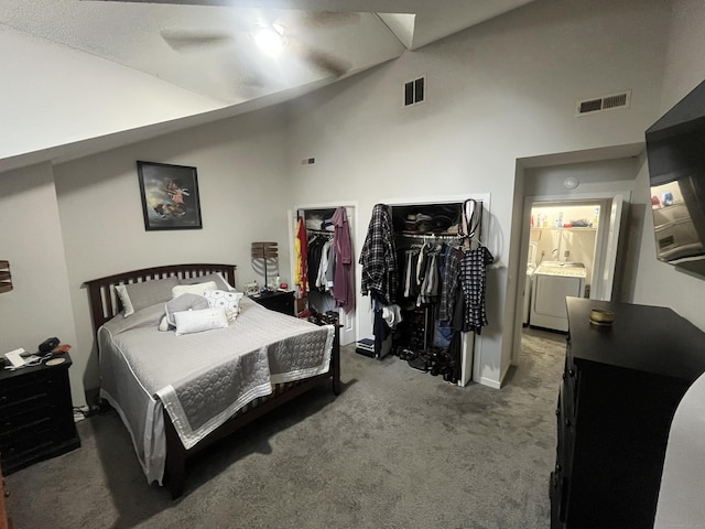 carpeted bedroom featuring vaulted ceiling, washing machine and clothes dryer, and visible vents