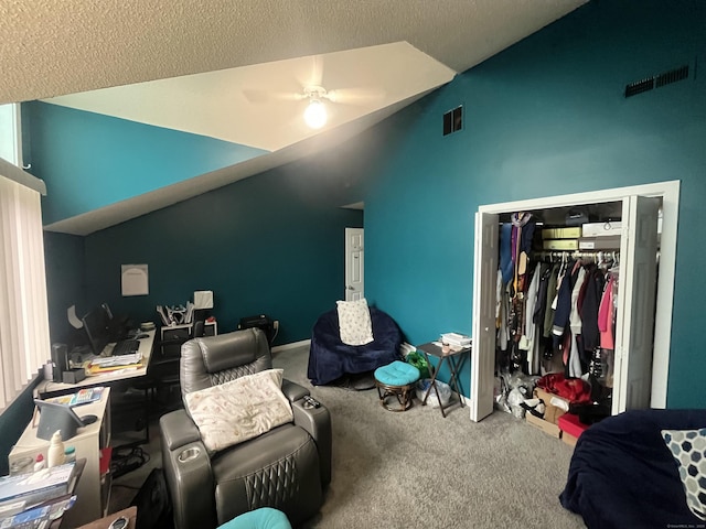 bedroom with carpet floors, a closet, visible vents, and vaulted ceiling