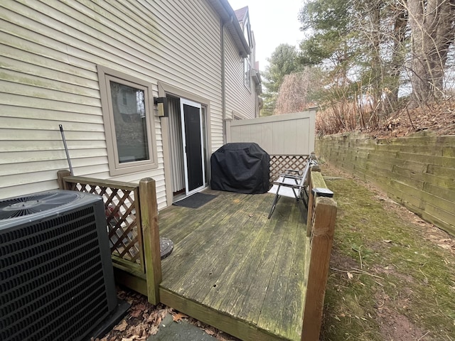 deck with central AC unit, grilling area, and fence