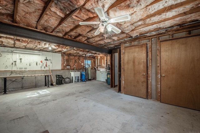 below grade area with washer / dryer, a ceiling fan, a sink, and a workshop area