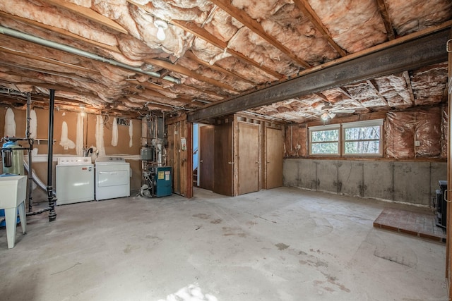 basement with washing machine and dryer and a heating unit