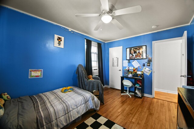 bedroom featuring baseboards, a ceiling fan, and wood finished floors