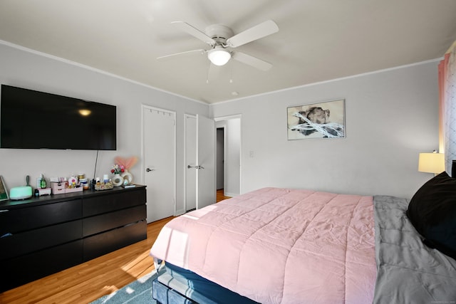 bedroom featuring crown molding, ceiling fan, and wood finished floors