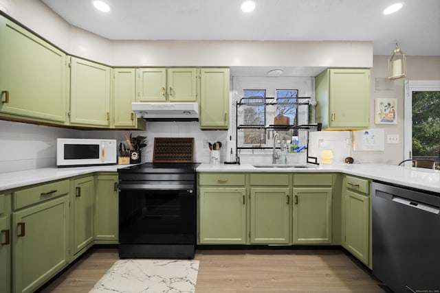 kitchen featuring black electric range, under cabinet range hood, green cabinetry, white microwave, and dishwasher