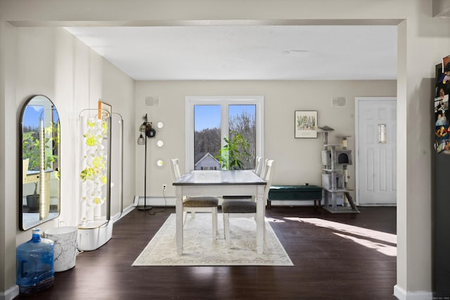 dining room featuring baseboards, dark wood-style flooring, and baseboard heating