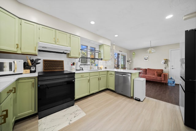 kitchen with black / electric stove, white microwave, green cabinetry, under cabinet range hood, and stainless steel dishwasher