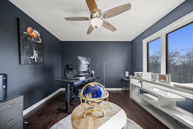 office space featuring baseboards, a textured ceiling, wood finished floors, and a ceiling fan