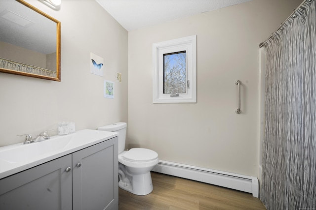 bathroom with toilet, a shower with curtain, wood finished floors, a baseboard radiator, and vanity