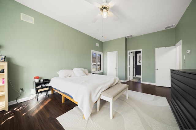 bedroom with visible vents, baseboards, and wood finished floors