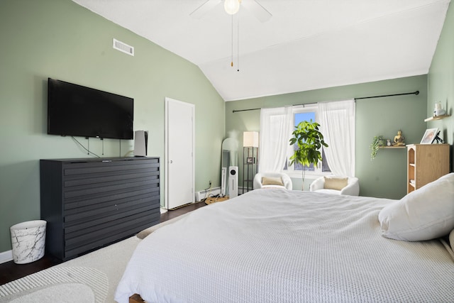 bedroom with visible vents, a ceiling fan, a baseboard heating unit, wood finished floors, and lofted ceiling