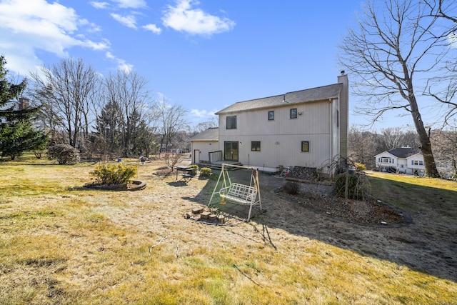 rear view of property with a chimney