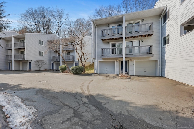 view of property with a garage and driveway